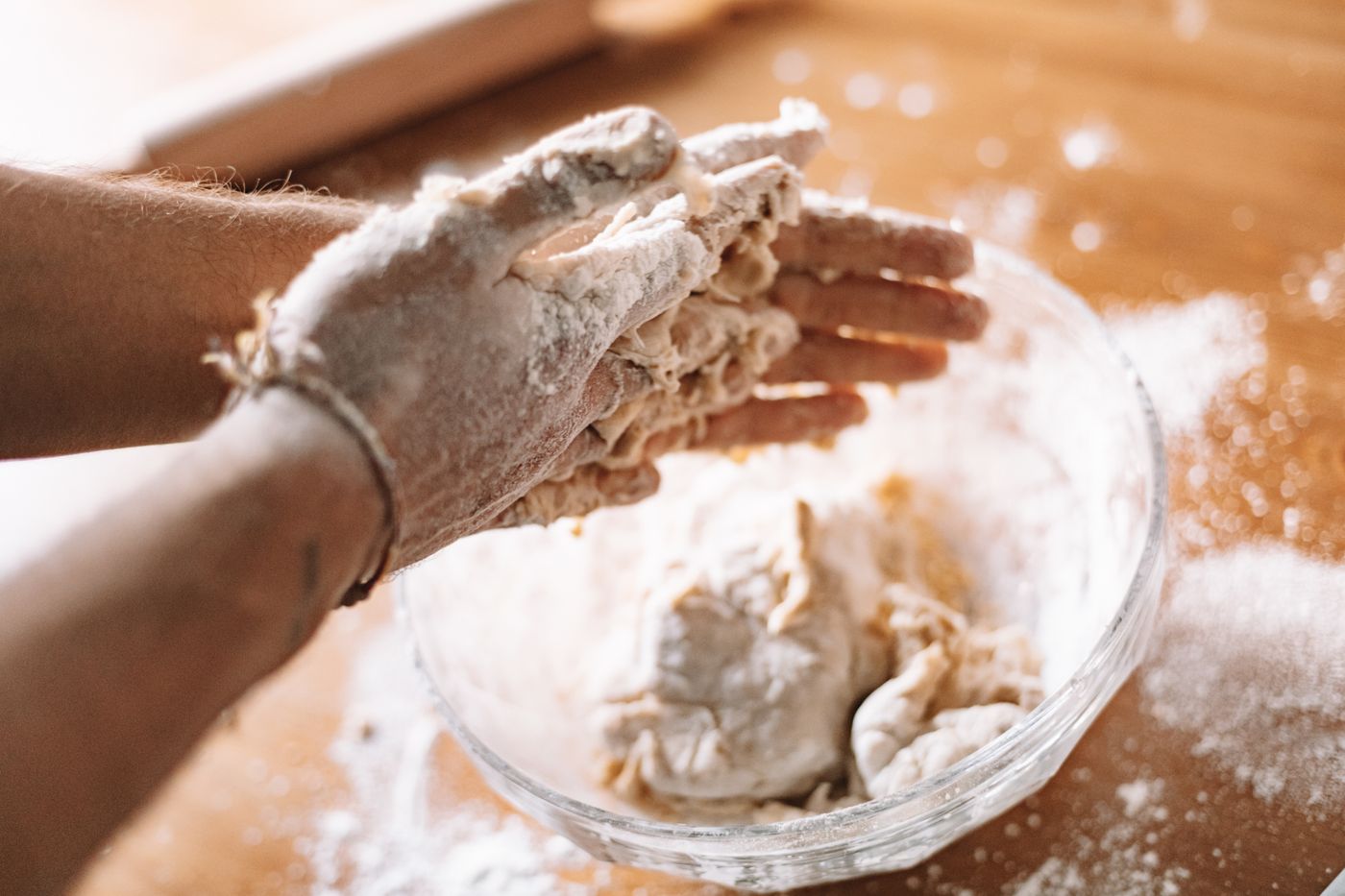 Les mains du boulanger travaillent la pâte farinée à quatre heures du matin