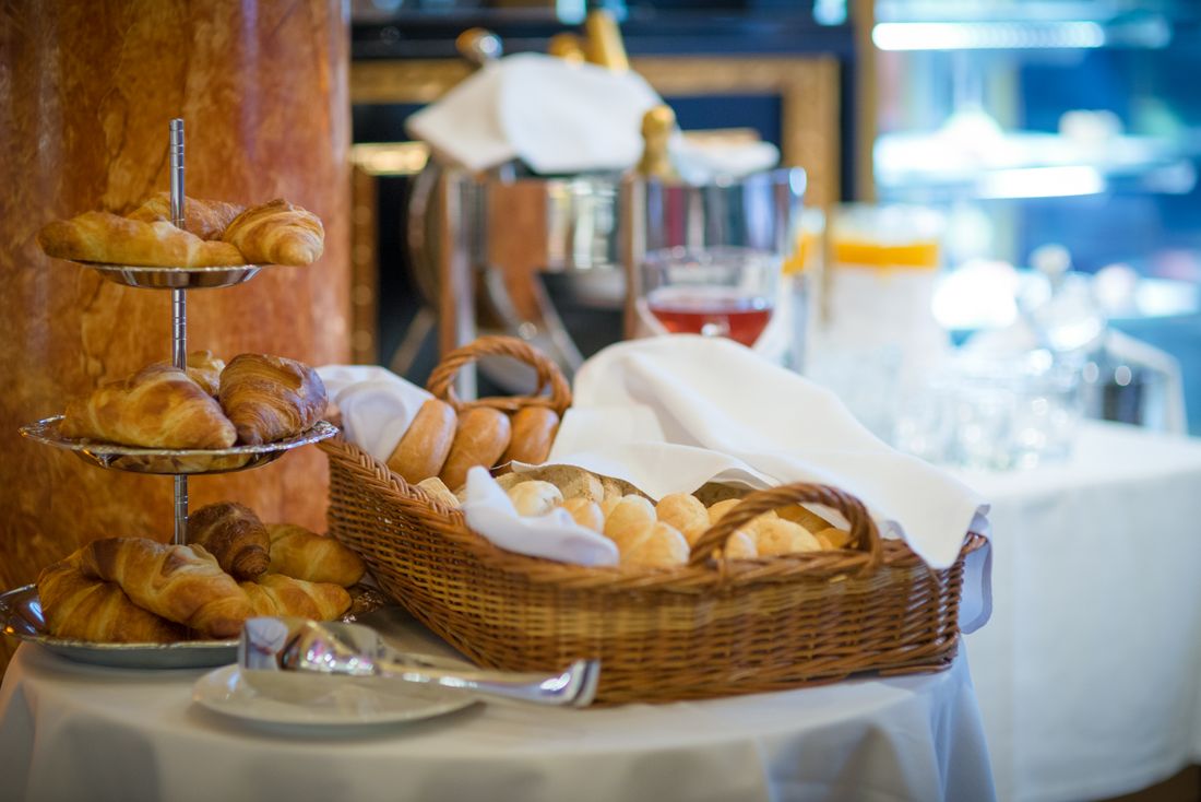 La table du matin dressée, viennoiseries et fleurs du jour